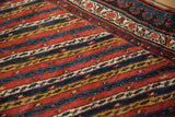 Detail of diagonal vine motifs and the pawn design border on an antique Kurdish runner.