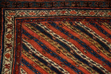 Corner close-up of an antique Kurdish rug showing the reciprocating pawn motif and hand-knotted pile.