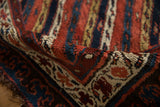 Detail of the even wool pile and bold reciprocating pawn motif on an antique Kurdish rug.