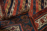 Original side cord selvage and dense hand-knotted pile on the corner of an antique Kurdish rug.