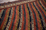 Even pile texture of the antique Kurdish runner, detailing the vine channels and pawn motif.