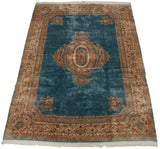 Luminous watery blue field highlights ornate floral medallion on this vintage Kerman carpet.