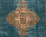Intricate raspberry red and beige floral bouquet motif on a watery blue vintage Kerman carpet.