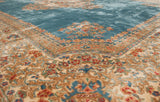 Intricate floral border in red, blue, and beige contrasting the Kerman rug's watery blue field.