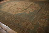 Serapi-inspired blossoms and buds on the antique ivory field of this Soumac carpet.