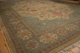 Serapi-inspired geometric border with terracotta, slate gray, ivory, and fringed rug corner.