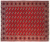 Vintage Bokhara design carpet with geometric elephant foot guls in a cherry red, black, and ivory palette.