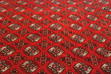 Detail of repeating elephant footprint guls in black and ivory on a plush cherry red field.