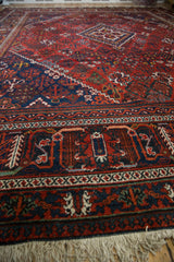 Hand-knotted vintage Joshegan carpet border with dusty brick, navy, and ivory fringe.