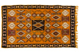 Vintage Moroccan rug with a saffron yellow field and geometric medallions in black, ivory, and aubergine.