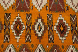 Geometric medallions in aubergine and ivory on the plush, saffron yellow pile of a Moroccan rug.