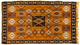 A vintage Moroccan rug featuring geometric medallions and stylized germinating plant motifs.