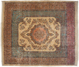 Fine vintage Kerman carpet with a Rococo medallion, millefleur ivory field, and intricate blue and red borders.