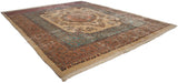 Angled view of a fine Kerman carpet showing its Rococo-style medallion and ivory millefleur field.