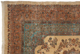 Corner of a vintage Persian Kerman rug featuring millefleur borders in peach and powder blue against an ivory field.