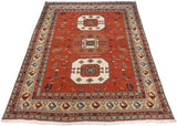 Vintage Meshkin carpet corner: terracotta field, stylized blue and rust birds, ivory fringe.