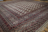 Angled view of a vintage Pakistani rug's corner with intricate, layered geometric borders.