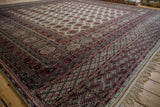 The detailed, multi-layered borders and neat ivory fringe of a fine Pakistani Bokhara carpet.