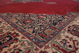 Angled view of the vintage Oushak carpet's lattice corner spandrel against the cherry red field.