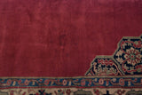 A faint area of staining visible on the black cherry red field of the vintage Oushak carpet.