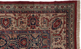 Intricate corner spandrel and borders of a vintage Oushak carpet in navy, red, and beige.