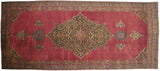 A monumental antique Khorassan carpet with a massive central medallion on a rich wine-red field.