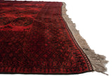 Angled view of the vintage Ersari carpet's full pile, side cord selvage, and fringe.