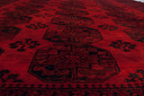 Low angle detail of the full wool pile and repeating black gul motifs on a vintage Ersari carpet.