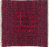 Vintage Ersari design square carpet with oversized gul motifs in fields of cherry red and navy charcoal.