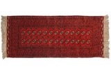 Vintage Daulatabad rug runner with repeating floral gul motifs in shades of cherry red and navy.
