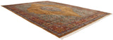 Perspective view of a vintage Tabriz carpet showing the golden medallion, seafoam field, and red borders.