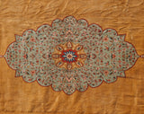 Scalloped center medallion with detailed floral bouquets on a pale seafoam green field.