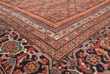 The intricate, mitered corner of an antique Fereghan carpet's Samovar turtle design main border.