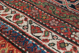 Close-up of the Samovar turtle border design with geometric vinery and saturated natural dyes.