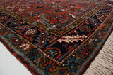 The full wool pile and intricate geometric border of a vintage Persian Mehrivan rug corner.