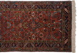 Corner of a vintage Mehrivan runner showing the intricate geometric border and clean ivory fringe.