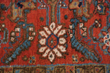 Detail of the full, hand-knotted pile featuring an ivory and sky blue Herati rosette.