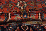 Close-up view of the dense, hand-knotted wool pile on a vintage Persian Mehrivan runner.