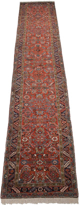 A close view of the hand-knotted pile, geometric border, and short ivory fringe on a Mehrivan runner.