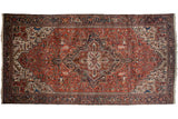 Vintage Persian Mehrivan carpet with concentric medallions on a brick red field and a classic navy blue Samovar border.