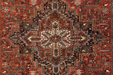 Geometric layered floral design motif within the concentric center medallion of a Mehrivan carpet.