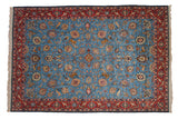 Vintage Persian Qom carpet with a pictorial hunt scene on a sky blue field and a detailed red border.