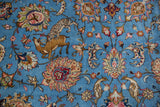 A finely drawn tiger hunting its prey among palmettes on the sky blue ground of a Persian carpet.