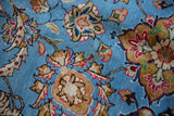 Finely drawn lotus flowers in saffron and rose on the tight, sky blue pile of a vintage Qom carpet.