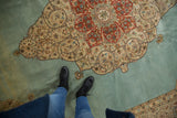 A personal viewpoint showing the scale and plush pile of the vintage Persian Tabriz carpet.