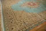 Intricate trefoil corner spandrel and scrolling floral border on a vintage Persian Tabriz rug.