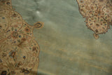 A close view of the full pile and beautifully abrashed seafoam blue field of the Tabriz carpet.