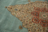 Close-up of the trefoil spandrel and scrolling tendrils on a vintage Persian Tabriz carpet.