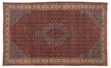 Oversize vintage Ardebil carpet with a rust field, concentric sky blue medallions, and an allover Herati design.