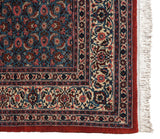 Vintage Ardebil carpet corner showing sky blue Herati motifs, ivory borders, and clean white fringe.